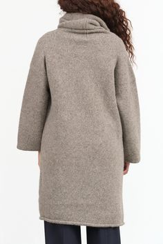 The Capote Coat is a stylish long cardigan featuring long sleeves, a relaxed hood, and a drop shoulder design, making it an ideal layering piece for the fall season. Made from softly felted Alpaca, it offers both comfort and warmth, ensuring you stay chic and cozy all season long. Oversized Turtleneck Outerwear For Fall, Oversized Funnel Neck Outerwear For Fall, Cozy Turtleneck Outerwear For Layering, Cozy Wool Long Sleeve Sweater Coat, Fall Cashmere Long Sweater Coat, Long Cashmere Sweater Coat For Fall, Oversized Cozy Wool Coat For Winter, Cashmere Long Sweater Coat For Fall, Cozy Oversized Wool Coat For Winter