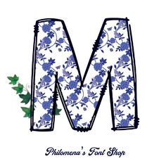 the letter m is made up of blue flowers and holly leaves on a white background