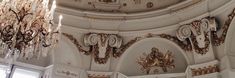 an ornate chandelier hangs from the ceiling