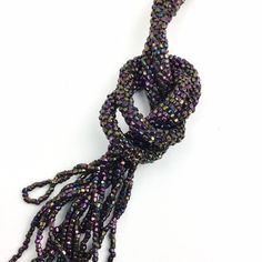 "Vintage 20s Iridescent Beaded Sautoir Lariat Necklace with Fringed Tassels, Eggplant Purple, Copper Brown, 54\", Art Deco Flapper Accessories COLOR: Wonderful dark iridescent beads with hints of pinkish purple and copper. MATERIAL: Steel cut seed beads. MEASUREMENTS: 54 in.(137 cm) WEIGHT: 40 g. CONDITION: Excellent. For more items like this: https://www.etsy.com/shop/iandrummondvintage PLEASE READ SHIPPING DISCLAIMER: We set our prices based on average shipping costs for domestic and internati Adjustable Lariat Beaded Necklaces For Parties, Bohemian Beaded Lariat Necklaces For Party, Bohemian Beaded Lariat Necklace For Parties, Bohemian Lariat Beaded Necklaces For Party, Adjustable Beaded Lariat Necklace For Parties, Beaded Chain Lariat Necklace For Party, Party Lariat Necklace With Beaded Chain, Adjustable Lariat Beaded Necklaces With Tassels, Adjustable Beaded Tassel Necklace For Party