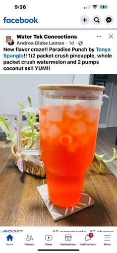 an orange drink sitting on top of a wooden table