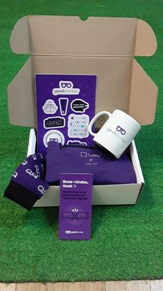 the purple box is filled with coffee and other items for sale on the green grass