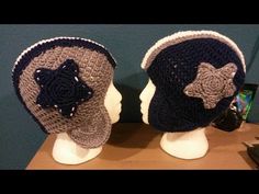 two crocheted hats are sitting on top of a head mannequins