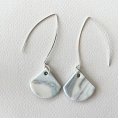 "porcelain and sterling silver long dangle earrings handmade pale blue white gray nerikomi minimalist simple contemporary modern These dangle earrings are handmade by me from porcelain clay and sterling silver. I've used pigments to create porcelain clay of different colors and then combined the clays using various techniques, such as nerikomi, to create a dappled or striated effect. I leave the porcelain unglazed, resulting in a matte surface.  Porcelain is such a special material: strong, yet Modern White Teardrop Linear Earrings, White Sterling Silver Long Drop Earrings, White Minimalist Long Drop Earrings, White Minimalist Dangle Linear Earrings, Minimalist White Dangle Linear Earrings, Minimalist White Linear Long Drop Earrings, Minimalist Gray Sterling Silver Jewelry, Minimalist Gray Jewelry For Everyday, Gray Minimalist Jewelry For Everyday