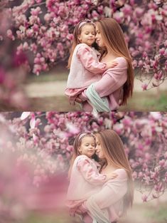 two girls hugging each other in the middle of a tree with pink flowers on it