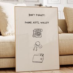 a sign on the floor that says don't forget phone keys wallet