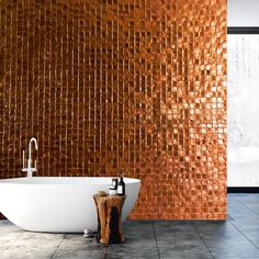 a bath tub sitting next to a wooden stool in front of a wall covered with tiles