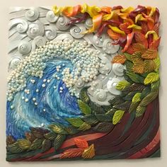 an art piece with leaves and waves on it