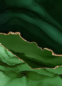 an abstract green and gold background with wavy lines in the center, as if it were fluid painting