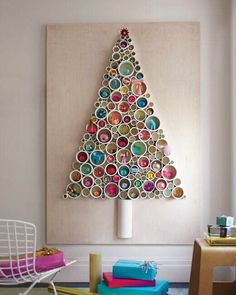 a christmas tree made out of toilet paper rolls is displayed on the wall in this room