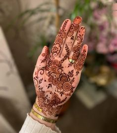 a woman's hand with henna on it