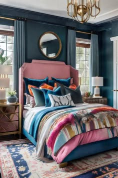 a bedroom with blue walls, pink bedding and colorful comforter on the bed