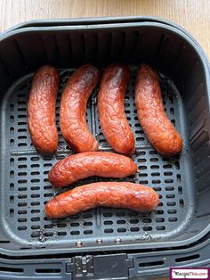 some sausages are in a black container on a table