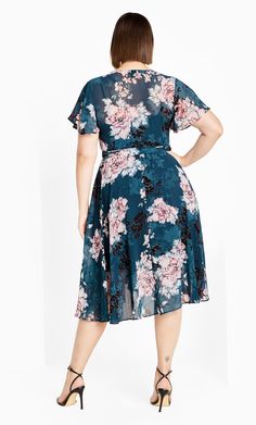 Wrap your curves in feminine florals with the ever flattering Blossom Short Sleeve Dress. This dreamy dress boasts a true wrap closure and plunging V-neckline, completed with a fitted cami slip. Key Features Include: - Floral print - Plunging V-neckline - Short flutter sleeves - True wrap closure - Fitted cami slip included - Knee length Style with block heels and vibrant makeup for a party look to remember! | Plus Size Short Sleeve Dress in Jade Blossom, Size 20 | City Chic V-neck Floral Print Wrap Dress For Garden Party, Floral Print V-neck Wrap Dress For Garden Party, Flowy Floral Dress With Surplice Neckline For Garden Party, Garden Party Floral Wrap Dress With Surplice Neckline, Flowy V-neck Floral Print Wrap Dress, Feminine Floral Print V-neck Wrap Dress, Floral Print Midi Dress With Surplice Neckline For Brunch, Floral Print Dress With Surplice Neckline For Brunch, Flowy Floral Dress With Surplice Neckline