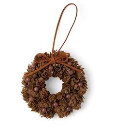 a pine cone wreath hanging from a brown ribbon