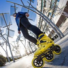 a man riding a skateboard down the side of a metal walkway next to a tall building