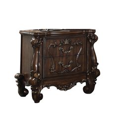 an ornate wooden cabinet with drawers and carvings on the front, against a white background