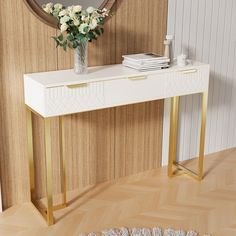 a white and gold console table with flowers on top