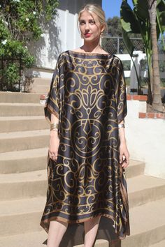 Sophisticated and elegant, this beautiful kaftan/tunic will provide a wonderful look for many occasions.  It is a deep, navy blue (almost black) with a scroll pattern of brownish, gold.  The smooth, silky, non-sheer poly fabric will make you feel like a million.   One size.  Fits many sizes from small to large.  The width is 43 inches from edge to edge, 86 inches around the body.  The side seams are 5 inches from the edge, giving 66 inches for body room and elegant movement.  The length is 45 in Chic Silk Kaftan For Beach Cover-up, Chic Evening Kaftan Tunic, Chic Silk Tunic Kaftan, Elegant Dress With Kimono Sleeves For Vacation, Elegant Flowy Kaftan For Vacation, Elegant Maxi Beach Tunic, Bohemian Summer Evening Kaftan, Elegant Tunic Kaftan For Beach, Evening Kaftan With Kimono Sleeves For Summer