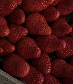 a box filled with lots of red strawberries