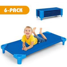 a young boy laying on top of a blue plastic bed with 6 - pack shelves in the background