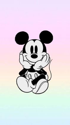 a cartoon mickey mouse sitting on top of a pink and blue background with the word disney written