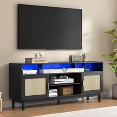 an entertainment center with a large flat screen tv mounted on it's sideboard