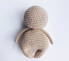 a crocheted stuffed animal sitting on top of a white surface