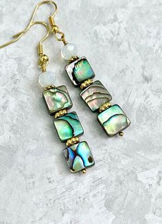 Abalone Moonstone Earrings ☀️ These Earrings have 8/10mm Abalone Shell and 6mm faceted Moonstones... the Earrings measure approximately 2.2 inches long with Gold Plated ear wires... Each piece of Abalone Shell is  unique with naturally beautiful imperfections... You will receive a pair of Earrings similar too but not the same to the earrings in the pictures... the colors may change slightly depending upon the light...  ✨  Visit our Etsy Shop for ....  Turquoise, Agate, Lapis, Coral, Jasper...  and more...  https://www.etsy.com/shop/CrystalHavenDesign 🌻 Iridescent Mother Of Pearl Dangle Jewelry, Adjustable Dangle Earrings In Mother Of Pearl, Earrings Gold Long, Beautiful Imperfections, Abalone Jewelry, Abalone Earrings, Earring Ideas, Moonstone Earrings, Ear Rings