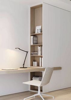 a white chair sitting in front of a desk with a book shelf on top of it