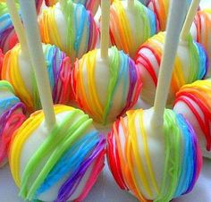 there are many colorful candy lollipops on the table