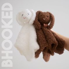 two stuffed animals are being held by someone's hand with the words hooked up above them