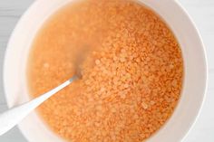 a white bowl filled with soup on top of a table