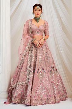 a woman in a pink lehenga and matching blouse