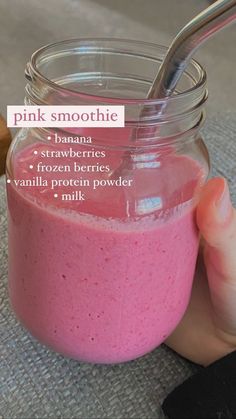 a pink smoothie in a glass jar with a spoon