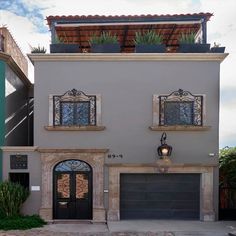 a two story house with an attached garage and balcony above the front door is shown