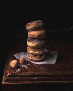 a stack of doughnuts sitting on top of a wooden table