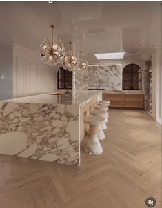 an image of a kitchen with marble counter tops and island in the middle, surrounded by wood flooring