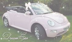 a pink car with a bow on the top