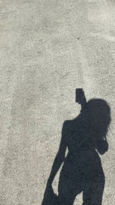 a shadow of a person holding a skateboard