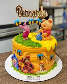 a winnie the pooh birthday cake on a table