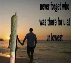 two people holding hands while walking on the beach with a large object in front of them that says never forget who was there for us at ur lowest