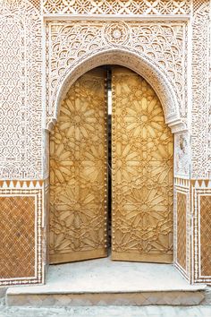 an intricately carved wooden door is open