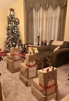 christmas presents are wrapped in brown paper with reindeer faces on them and tied to boxes