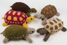 three crocheted turtle and two tortoises on a white background