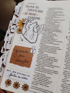 an open bible with stickers on the pages and writing in spanish next to a cup of coffee