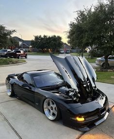 a black sports car with its hood open