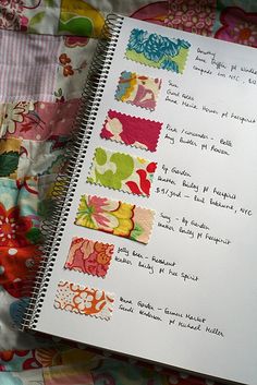 an open notebook on top of a colorful quilt