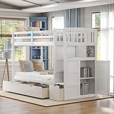 a white bunk bed sitting on top of a hard wood floor next to a window