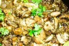 chicken and mushroom stew with cilantro in a slow cooker, garnished with parsley